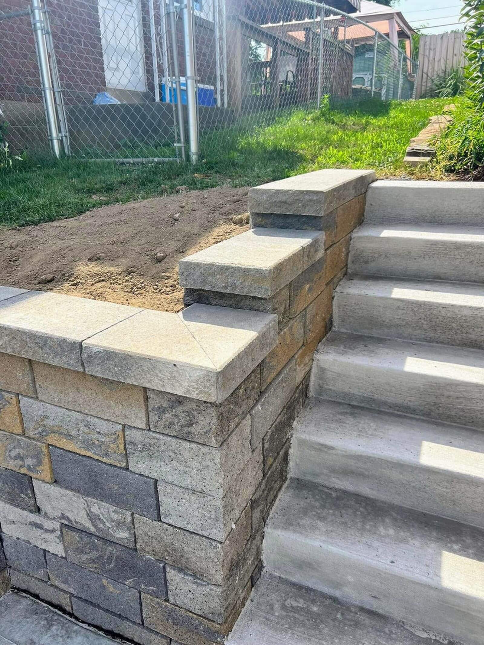 New retaining wall and stair system replacing a failing timber wall