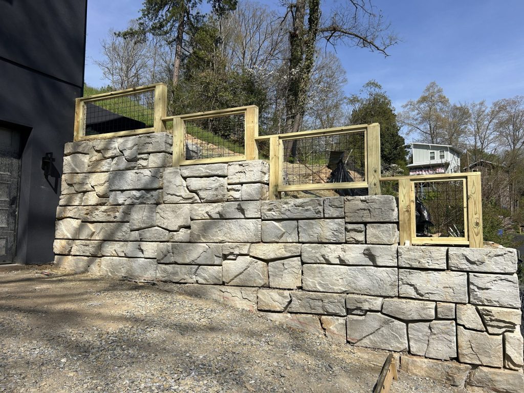 Modern block retaining wall installation designed for structural support, drainage performance, and clean landscape integration