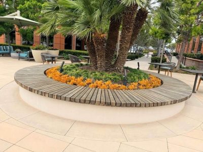 Decorative retaining wall surrounding a landscaped courtyard in Newport Beach