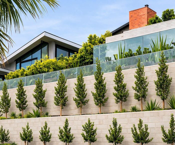 Segmental retaining wall supporting a landscaped hillside property